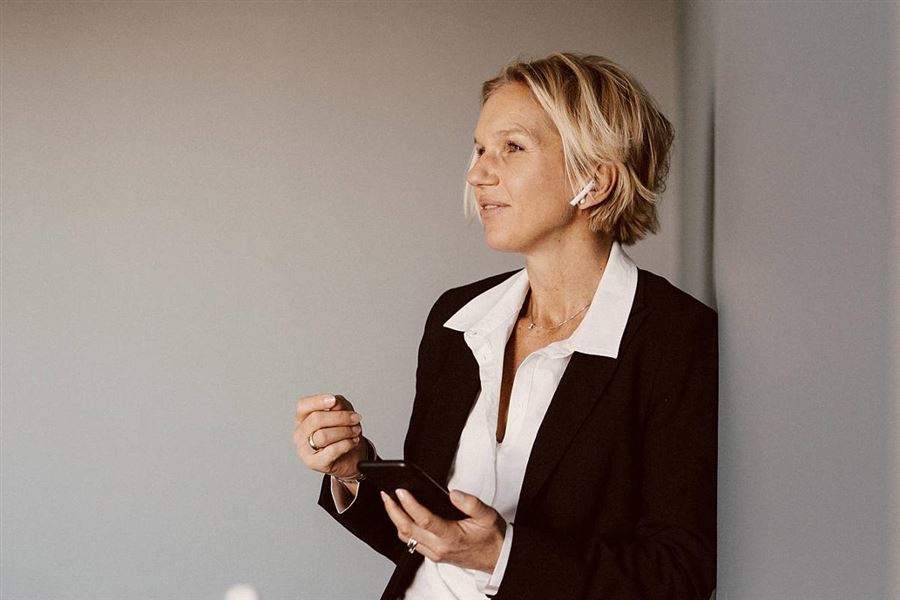 A business woman is discussing something over the phone.